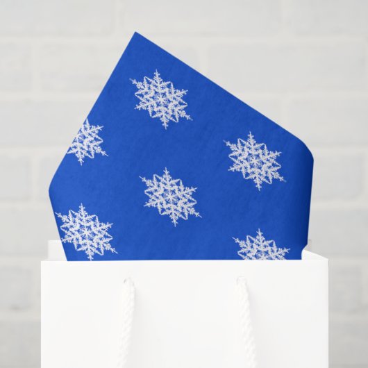 Wit sneeuwvlokkenpatroon op blauw tissuepapier (Cadeauzakje)