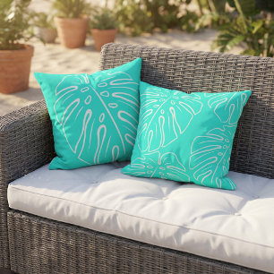 Wit tropisch bladmotief op aqua turquoise blauw buitenkussen