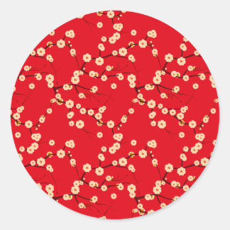 Witte bloesems op rood ronde sticker