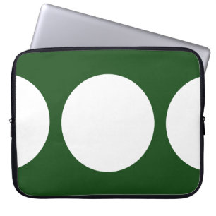 Witte cirkels op groen laptop sleeve