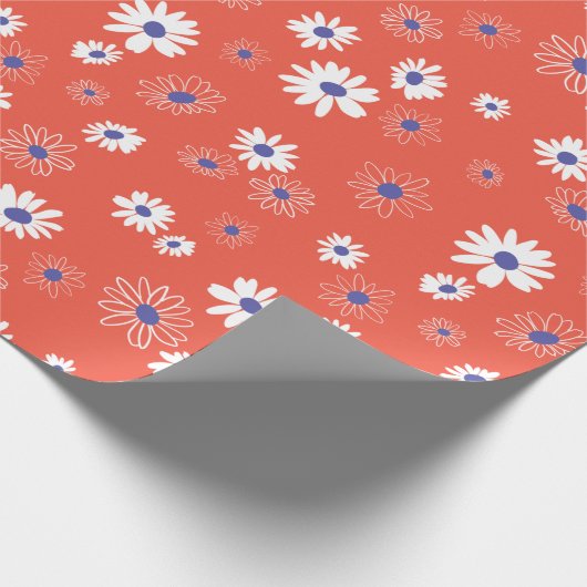 Witte en blauwe daisy bloemen op rood cadeaupapier (Hoek)