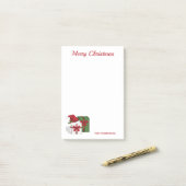 Witte en groene cadeaudozen met een kerstmuts post-it® notes (Op bureau)