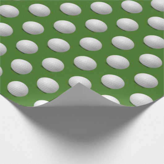 witte golfbal op groen cadeaupapier (Hoek)