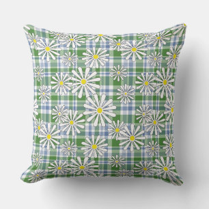 Witte kamillebloemen op een groen blauw geruit kussen