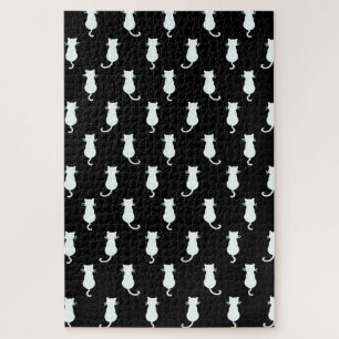 Witte kat geïsoleerd op zwart stippenpatroon legpuzzel