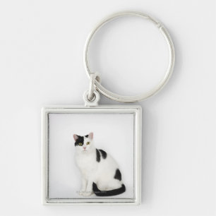 Witte kat met zwarte vlekken sleutelhanger