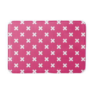 Witte kruisstiften op fuchsia badmat