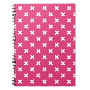 Witte kruisstiften op fuchsia notitieboek