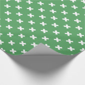 Witte kruisstiften op groen cadeaupapier (Hoek)