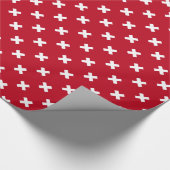 Witte kruisstiften op rood cadeaupapier (Hoek)