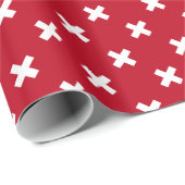 Witte kruisstiften op rood cadeaupapier (Rol Hoek)