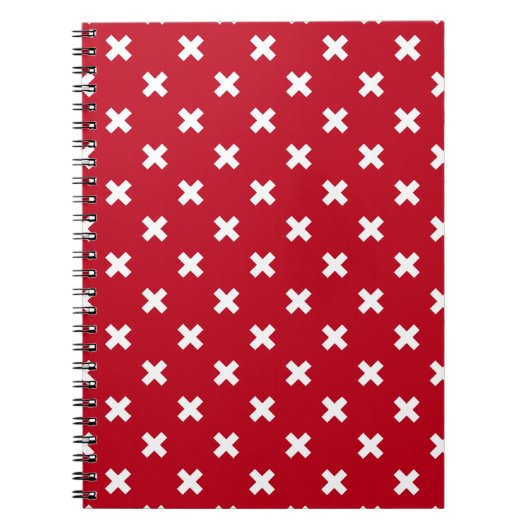Witte kruisstiften op rood notitieboek (Voorkant)