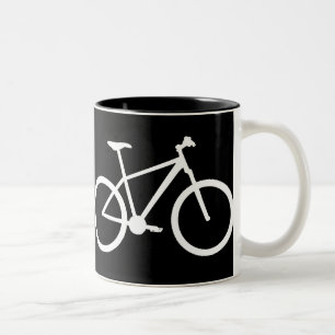 Witte mountainbike op zwarte mok. tweekleurige koffiemok