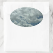 Witte, pluizige wolken aan de blauwe hemel ovale sticker (Tas)