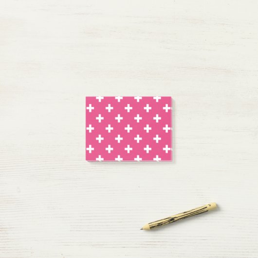 Witte polka kruist op fuchsia post-it® notes (Op bureau)