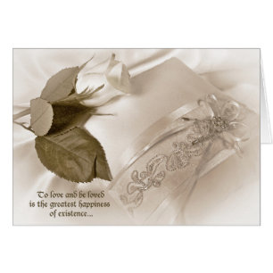 witte roos op huwelijkskussens