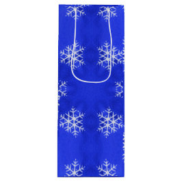 Witte sneeuwvlokken helderblauwe achtergrond wijn cadeautas