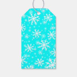 Witte sneeuwvlokken op aquablauw cadeaulabel