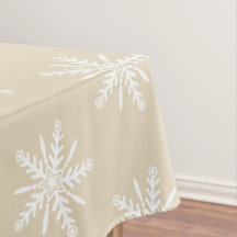 Witte sneeuwvlokken op beige Xmas tablecloth.