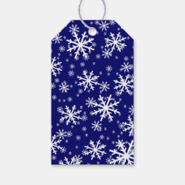 Witte sneeuwvlokken op donker marineblauw cadeaulabel