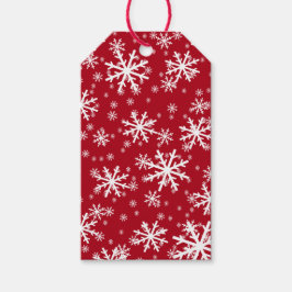 Witte sneeuwvlokken op donkerrood cadeaulabel