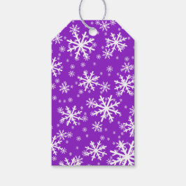 Witte sneeuwvlokken op paars cadeaulabel