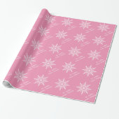 Witte sneeuwvlokken op roze cadeaupapier (Uitgerold)