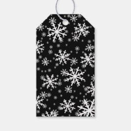 Witte sneeuwvlokken op zwart cadeaulabel