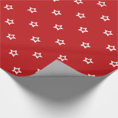 Witte sterren op helder rood cadeaupapier (Hoek)