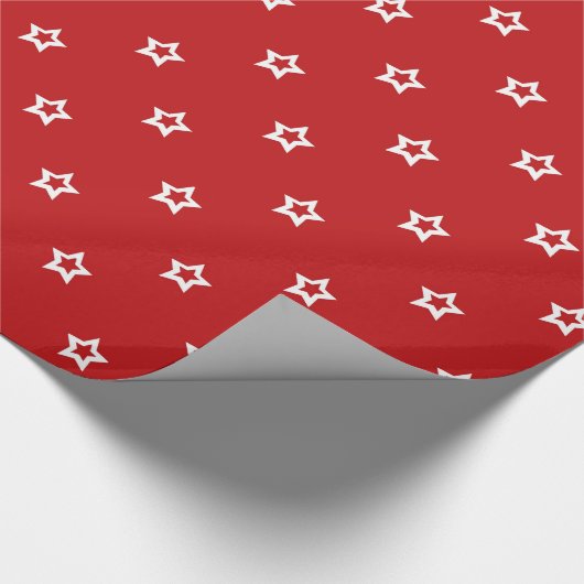 Witte sterren op helder rood cadeaupapier (Hoek)