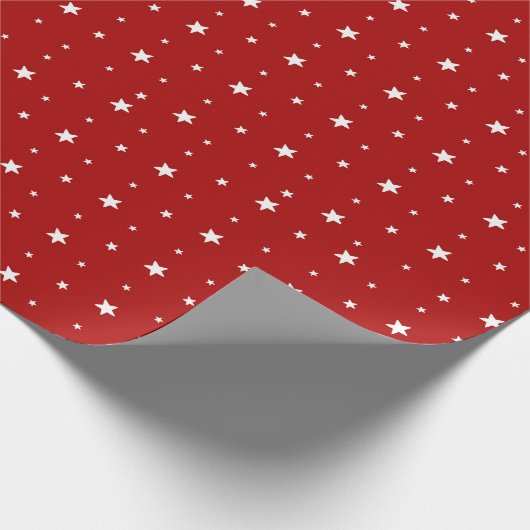 Witte sterren op rood cadeaupapier (Hoek)