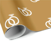  witte trouwringen op mat goud cadeaupapier (Rol Hoek)