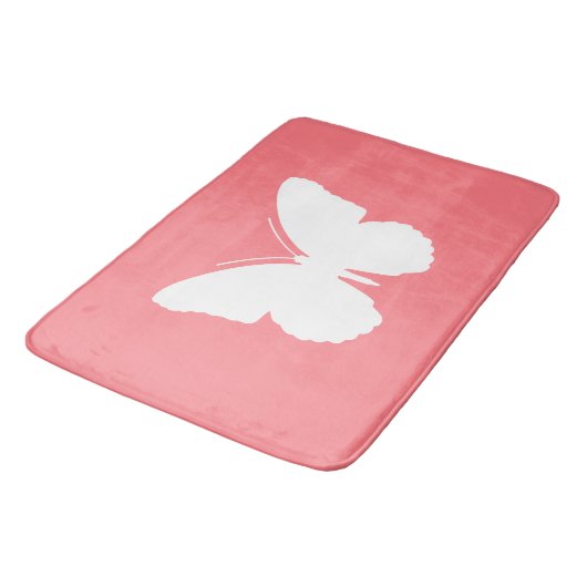 Witte vlinder op koraalroze badmat (Gekanteld)