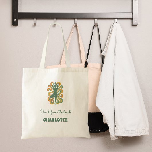 Yoga pose swirls green orange name slogan retro tote bag