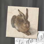 Young Hare | Albrecht Dürer Magneet<br><div class="desc">De jonge haas van Albrecht Dürer (1502) is een minutieus uitgewerkt waterverf schilderij met een levensechte afbeelding van een haas. Bekend om zijn buitengewone realisme, legt het kunstwerk de textuur van de vacht van de haas vast, het delicate licht in zijn ogen en het subtiele spel van schaduwen. Dit meesterwerk...</div>
