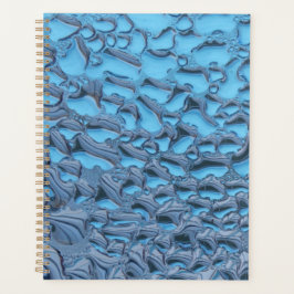 Zachte regendruppels op blauw glas planner