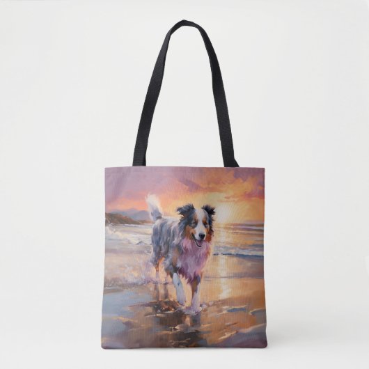 Zandige Australische Herder Hond op Strand Zonsond Tote Bag (Voorkant)
