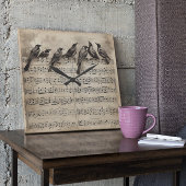 zangvogels zitten op een muziekverzameling vierkante klok