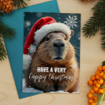 Zeer gelukkige Kerstmis Capybara Kerstmis Feestdagenkaart<br><div class="desc">Stuur dit vakantieseizoen wat Capy Christmas-juichen met deze grappige kerstkaart met ieders favoriete chill-dier - de capibara! Uitgedost in een feestelijke kerstmuts en omringd door sneeuwvlokken, brengt deze kaart een extra dosis humor naar uw vakantiewensen. Perfect voor het toevoegen van een eigenzinnige touch aan uw kersttradities, het is zeker om...</div>