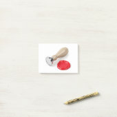 Zegel en zegel van de rode was post-it® notes (Op bureau)