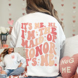 Zijn ik hem in het bruidsmeisje zijn ik gepersonal trui<br><div class="desc">Introductie van de "It's Me Hi I'm the Maid of Honor" Gepersonaliseerde sweatshirt - een trendy en schattige perzik koraal roze kledingstuk dat een vleugje plezier en stijl toevoegt aan de garderobe van je Maid of Honor. Dit coole vrijgezellenfeest shirt heeft een voor- en achterprint met retro golvende tekst, waardoor...</div>