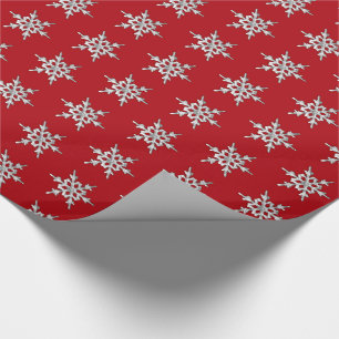 Zilver en witte sneeuwvlok op diep rood cadeaupapier