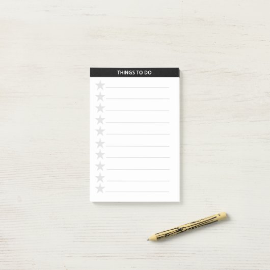 Zilver grijze sterren en zwarte koptekst post-it® notes (Op bureau)