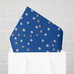 Zilveren en gouden polka stippen op blauw tissuepapier