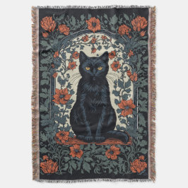 Zittende zwarte kat  bloemig deken
