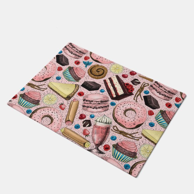 Zoete lekkernijen op roze deurmat (Schuin)