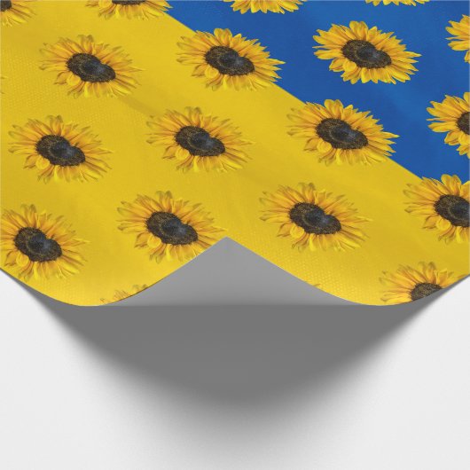 Zonnebloem van het hart op blauw en geel cadeaupapier (Hoek)