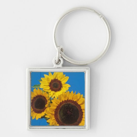Zonnebloemen tegen blauwe omheining sleutelhanger (Voorkant)