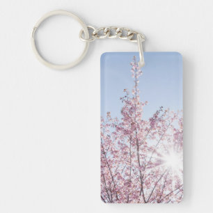 zonnestralen passeren roze bloemen van een wow - b sleutelhanger