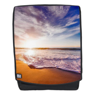 Zonsondergang op het strand rugtassen